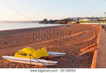 Pedalo on Goodrington beach near Paignton Devon England with colourful beach huts