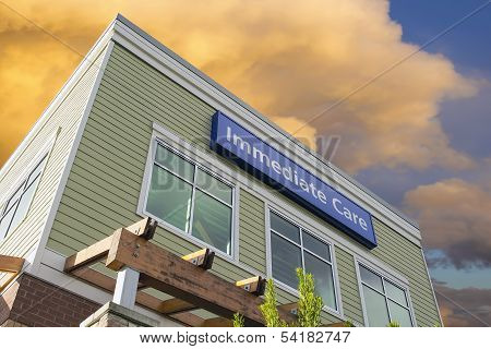 Immediate Care Sign On Hospital Building With Clouds