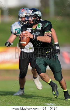 VIENNA,  AUSTRIA - JUNE 8 QB Jonathan Dally (#8 Dragons) runs with the ball during the AFL football game on June 8, 2013 in Vienna, Austria.