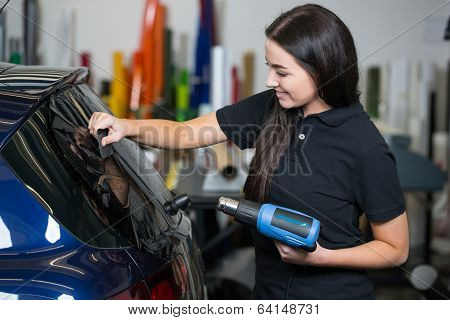 Car Wrapper Using Heat Gun And Squegee For Tinting Window