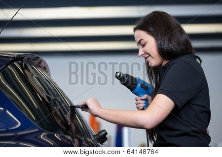 Car Wrapper Using Heat Gun And Squegee For Tinting Window