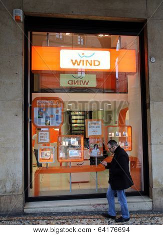 BOLOGNA, ITALY - APRIL 19, 2014: Pedestrians walk past a Wind Telecomunicazioni SpA mobile telephone store in Bologna, Italy, on Saturday, April 19, 2014. 