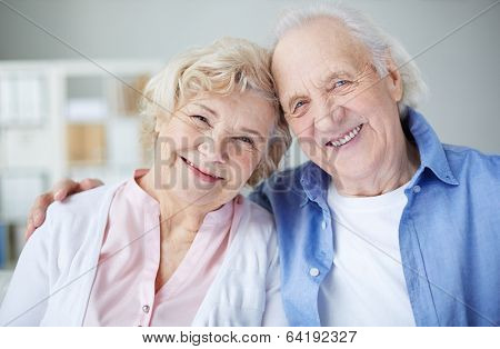 Portrait of cheerful seniors looking at camera with smiles