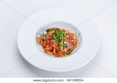 Pasta with shrimps, herbs and mashrooms isolated on white background in studio
