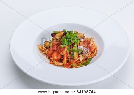 Pasta with shrimps, herbs and mashrooms isolated on white background in studio