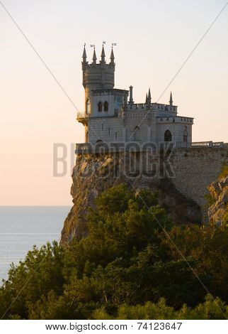 Old castle on cliff, at sunrise