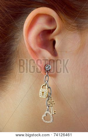 Macro of earring -  heart, key and lock