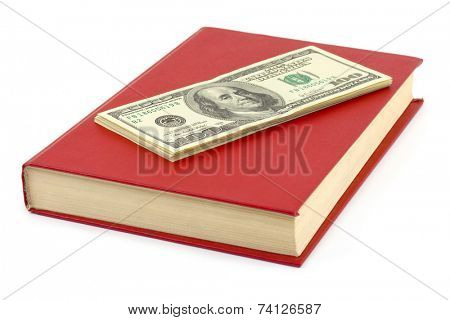 Money and book isolated on white background