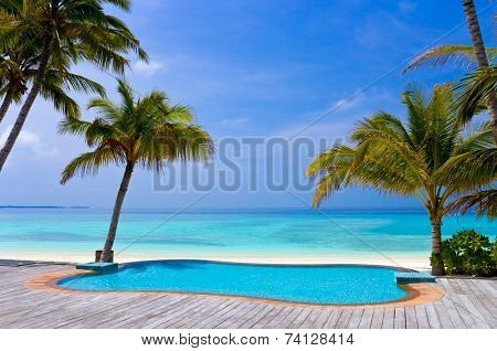 Pool on a tropical beach, vacation background