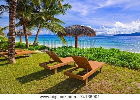 Chairs on tropical beach at Seychelles - vacation background