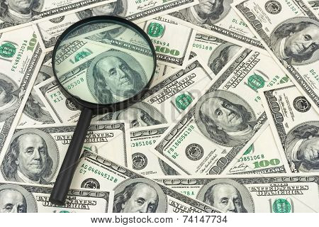 Magnifying glass and money - business background
