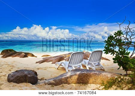 Chairs on tropical beach at Seychelles - vacation background