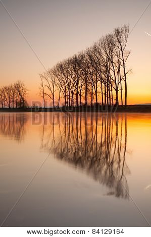 Symmetry On The River At Sunrise