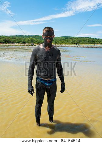 Man Applying Healing Clay