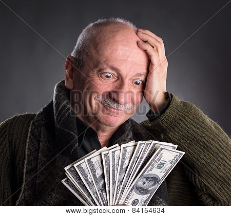 Lucky Elderly Man Holding Dollar Bills