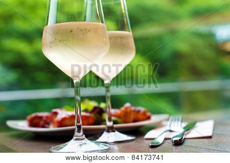 Two Glasses Of Delicious Cooled White Wine With Snack In Restaurant..