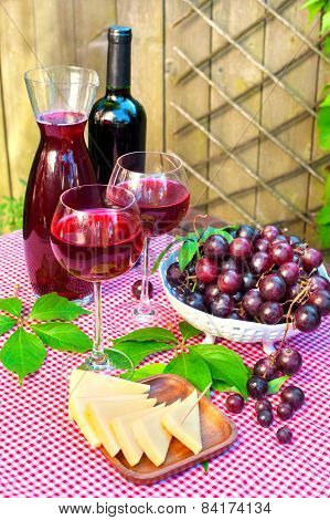 Two Glasses Of Delicious Homemade Semisweet  Red Wine With Grapes