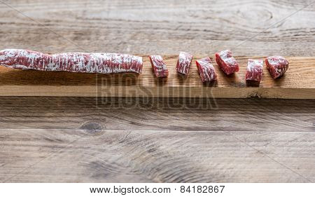 Cut Spanish Salami On The Wooden Board