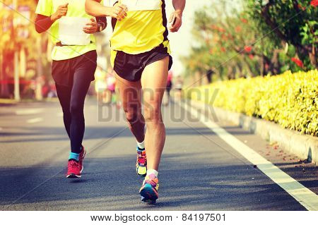 Marathon running race, people feet on city road