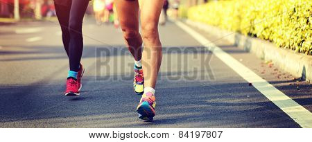 Marathon running race, people feet on city road