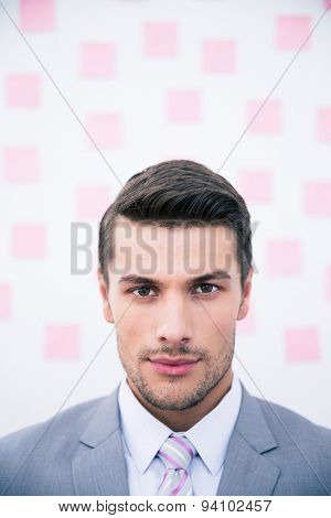 Portrait of a young handsome businessman looking at camera