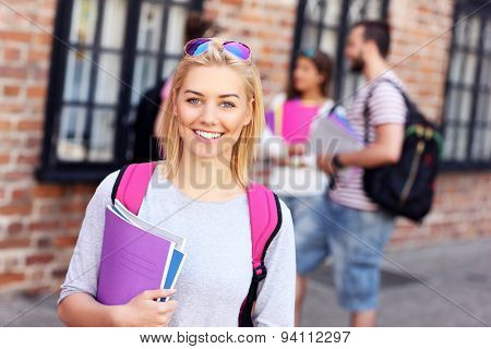 A picture of a group of happy students studying outdoors