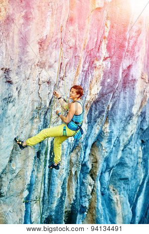 Rock climber climbing up a cliff