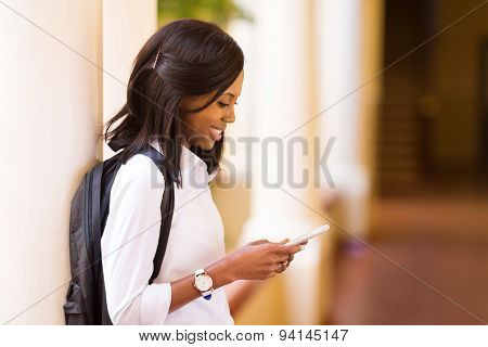 pretty female afro american university student using cell phone