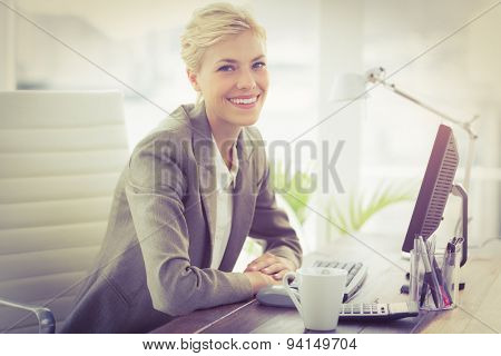 Smiling businesswoman lookingat camera in the office