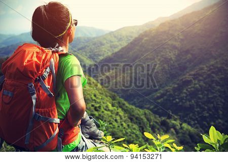 young woman backpacker enjoy the view at mountain peak