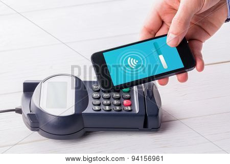 Loading screen against man using smartphone to express pay