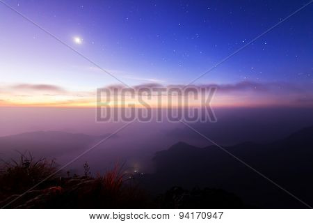 Sunrise scene with the peak of mountain and cloudscape