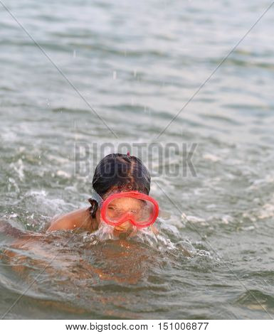 Little Girl Smiling While Playing With The Mask Diving Under Wat