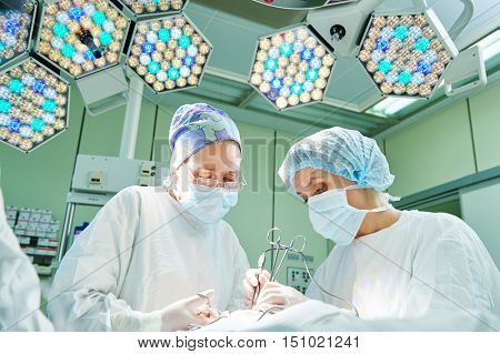 surgeons at work. female doctors operating in child surgery hospital
