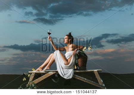 Pretty Woman With Wine Over Sky