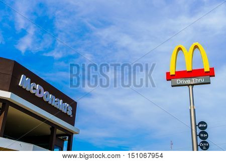 Khonkaen Province, Thailand - December 20, 2015 : McDonalds logo on blue sky McDonald's Corporation is the world's largest chain of hamburger fast food restaurants.