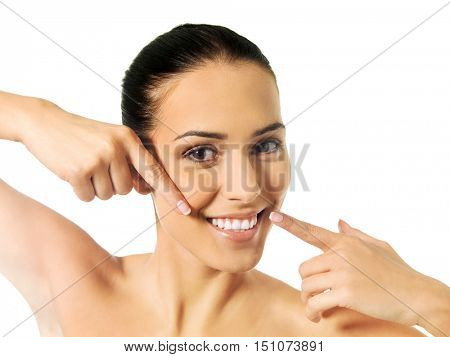 Dental health concept - beautiful woman pointing to her teeth