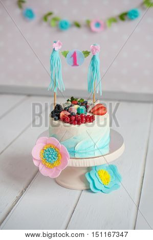 Blue cake with berries on the cake stand