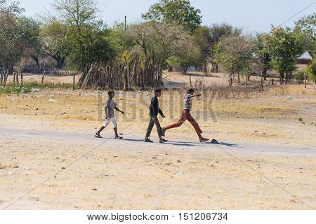 Caprivi, Namibia - August 20, 2016: Poor Teenagers Walking On The Roadside In The Rural Caprivi Stri