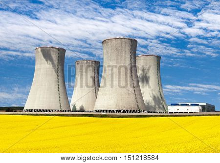 Nuclear power plant Dukovany with golden flowering field of rapeseed - Czech Republic - two possibility for production of energy
