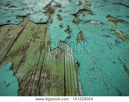 Wood background with old green peeling paint, horizontal view
