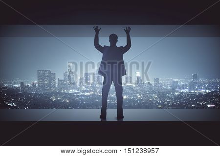 Struggling man between concrete walls on illuminated night city background. Pressure concept