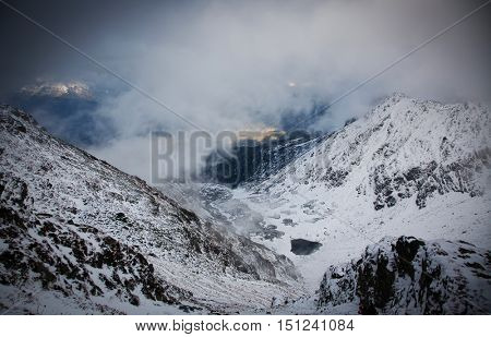 View on foggy valley in winter from Rodna Mountains in Transylvania - Romania