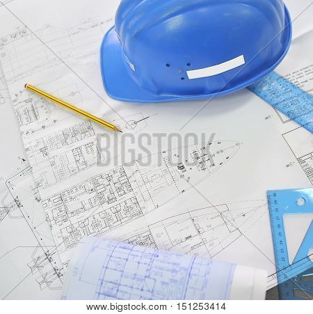 Technical naval projects paper and helmet, close up