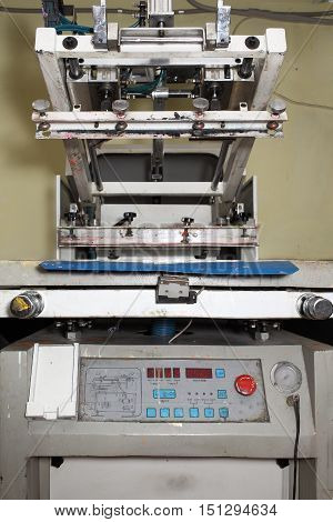 Old printing machine for serigraphy. Technical background