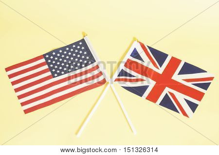British (UK) and American (USA) flags on yellow background