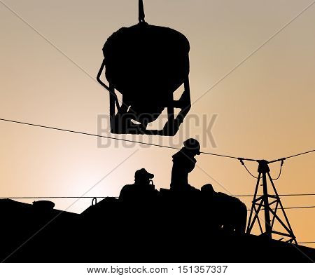 Silhouette engineer standing orders for construction crews to work safely on high ground over blurred natural background sunset pastel. heavy industry and safety at work concept.