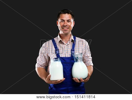 Handsome milkman on dark background