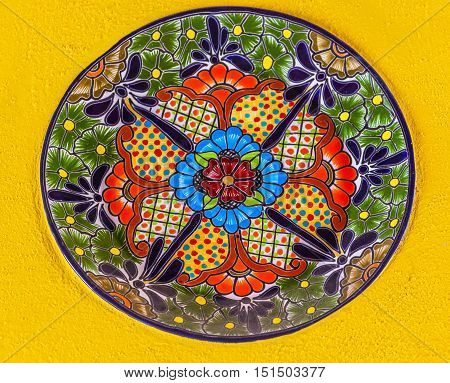 GUANAJUATO, MEXICO - DECEMBER 31, 2014 Colorful Ceramic Mexican Plate Yellow Wall Guanajuato Mexico
