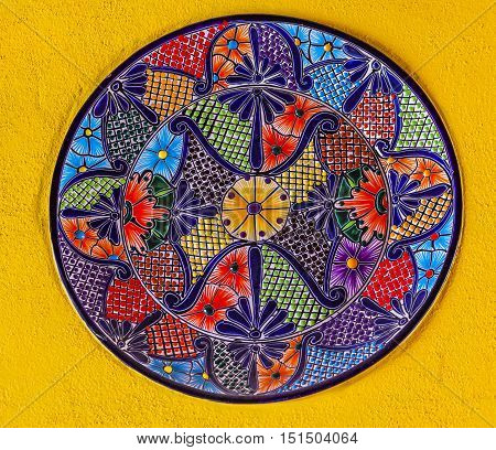 GUANAJUATO, MEXICO - DECEMBER 31, 2014 Colorful Ceramic Mexican Plate Yellow Wall Guanajuato Mexico